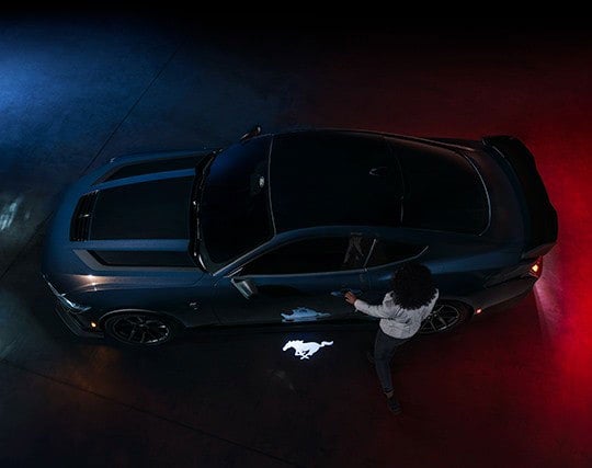 2024 Ford Mustang® Dark Horse™ model with a driver approaching the vehicle | Joe Ricci's Ordus Ford, LLC in Bad Axe MI